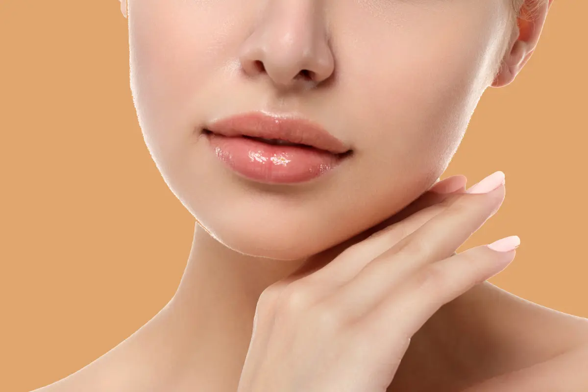 Close up view of young beautiful caucasian woman touching her face isolated over white background. Lips contouring, SPA therapy, skincare, cosmetology and plastic surgery concept